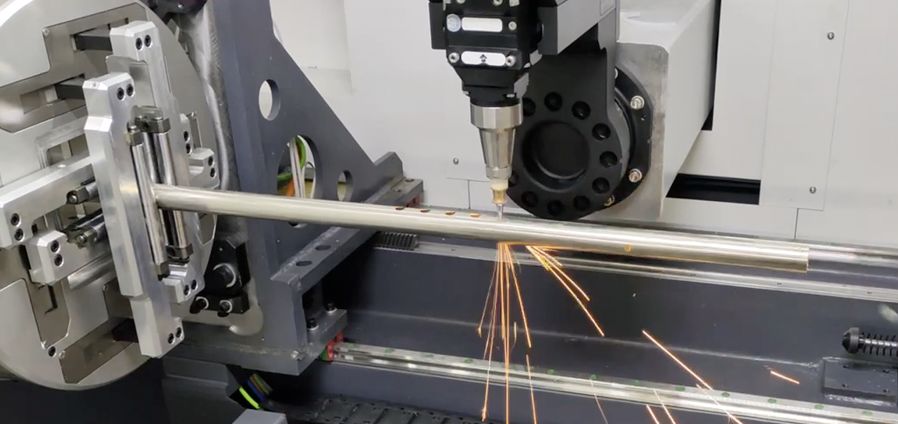 Tube laser chuck gripping a length of steel pipe