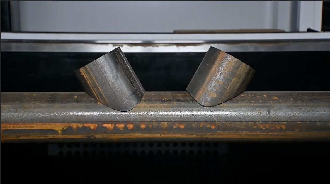 Fabricator checking fit-up of laser-cut steel components