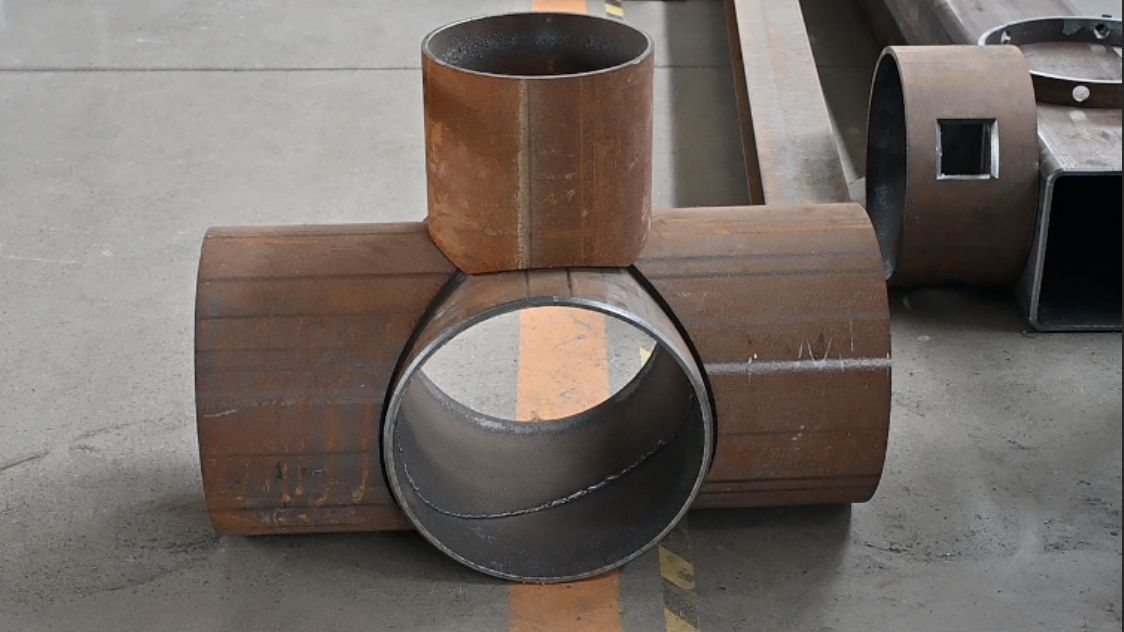 Fabricated steel pipe tee component ready for weld-out