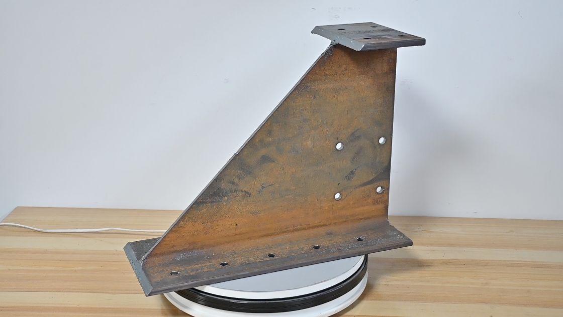 Welded structural steel gusset bracket with mounting holes