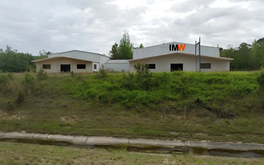Exterior of the Industrial Machine Worx precision laser fabrication facility in Alabama, with the IMW sign on the building