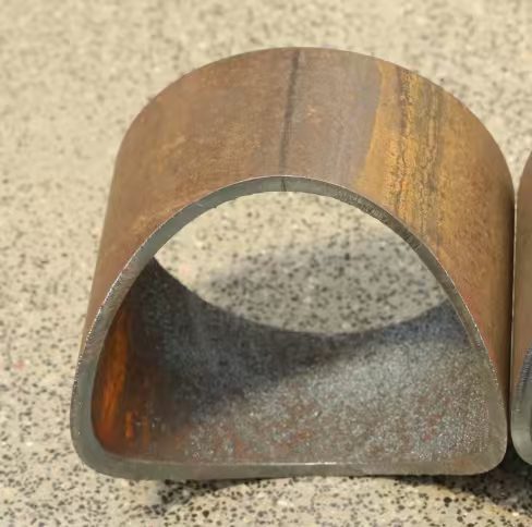 Saddle-coped round steel pipe end laser-prepared for welding